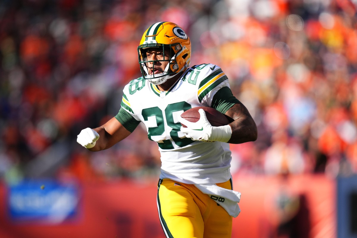 Oct 22, 2023; Denver, Colorado, USA; Green Bay Packers running back AJ Dillon (28) carries the ball in the second quarter against the Denver Broncos at Empower Field at Mile High. Mandatory Credit: Ron Chenoy-USA TODAY Sports  
